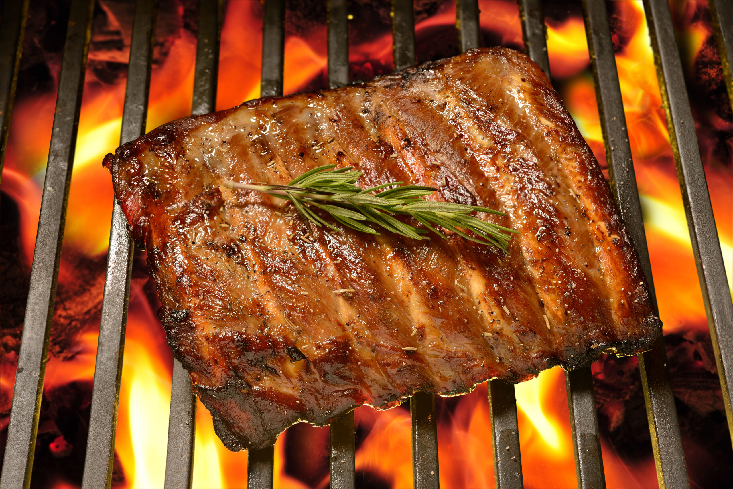 Grilled pork ribs on the flaming grill